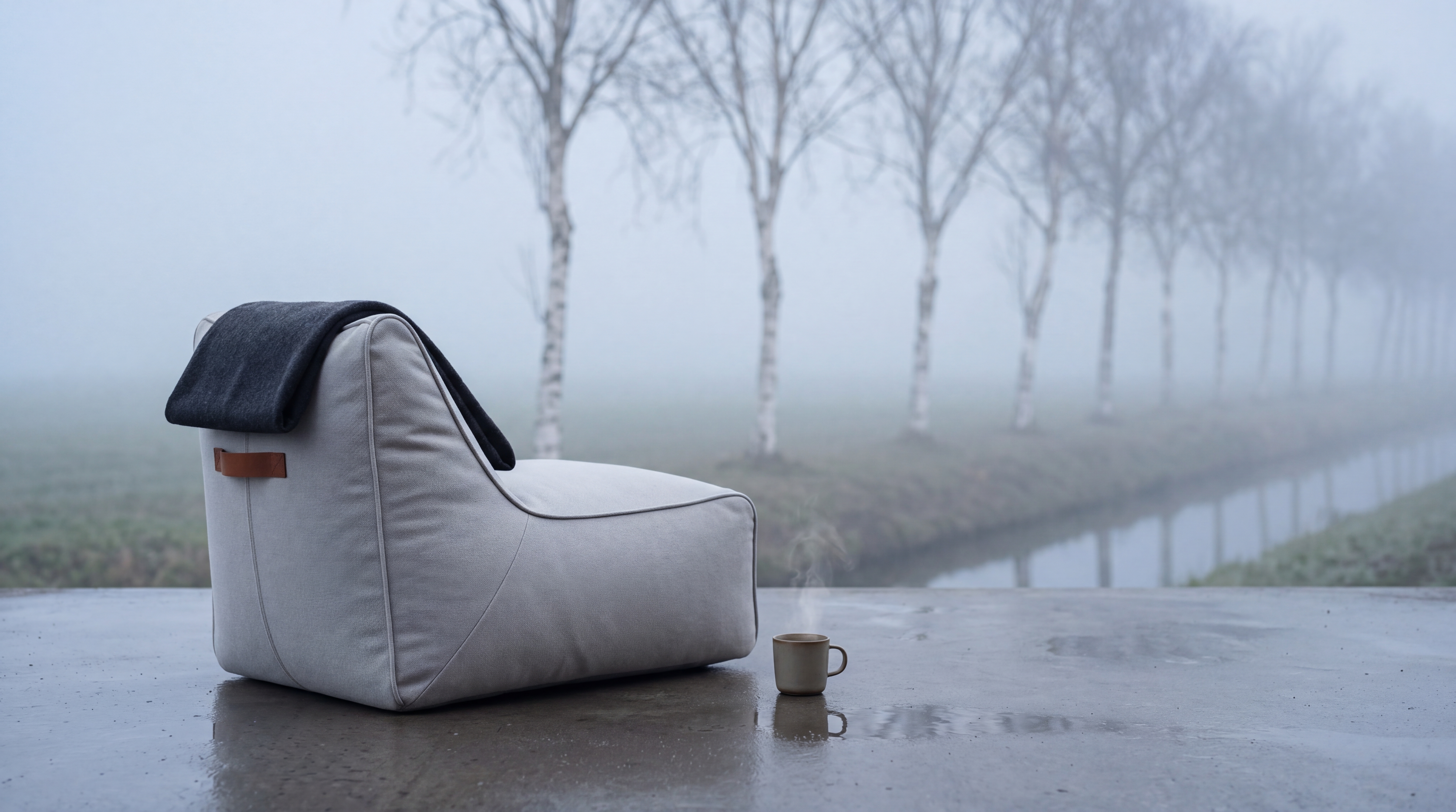 Mist-coloured ruusta lounge chair among Dutch birch trees